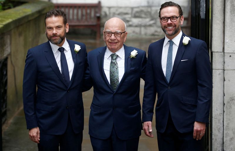 Rupert Murdoch posing with sons Lachlan and James outside St Bride's church in London in March 2016