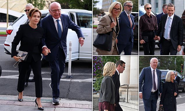 Rupert Murdoch and his wife walking into court through a crowd of reporters and photographers